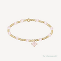 Gold and pink pearl bracelet on a white background with pink rhombus crystal charm
