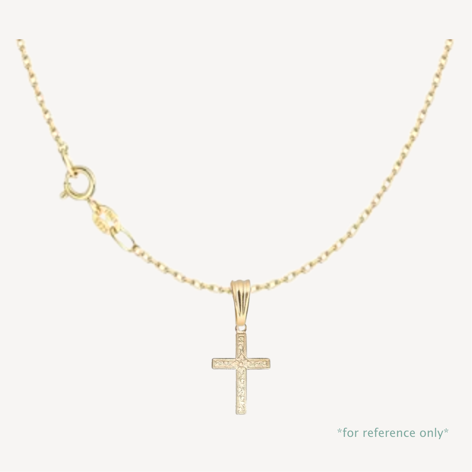 Gold cross pendant necklace on a white background