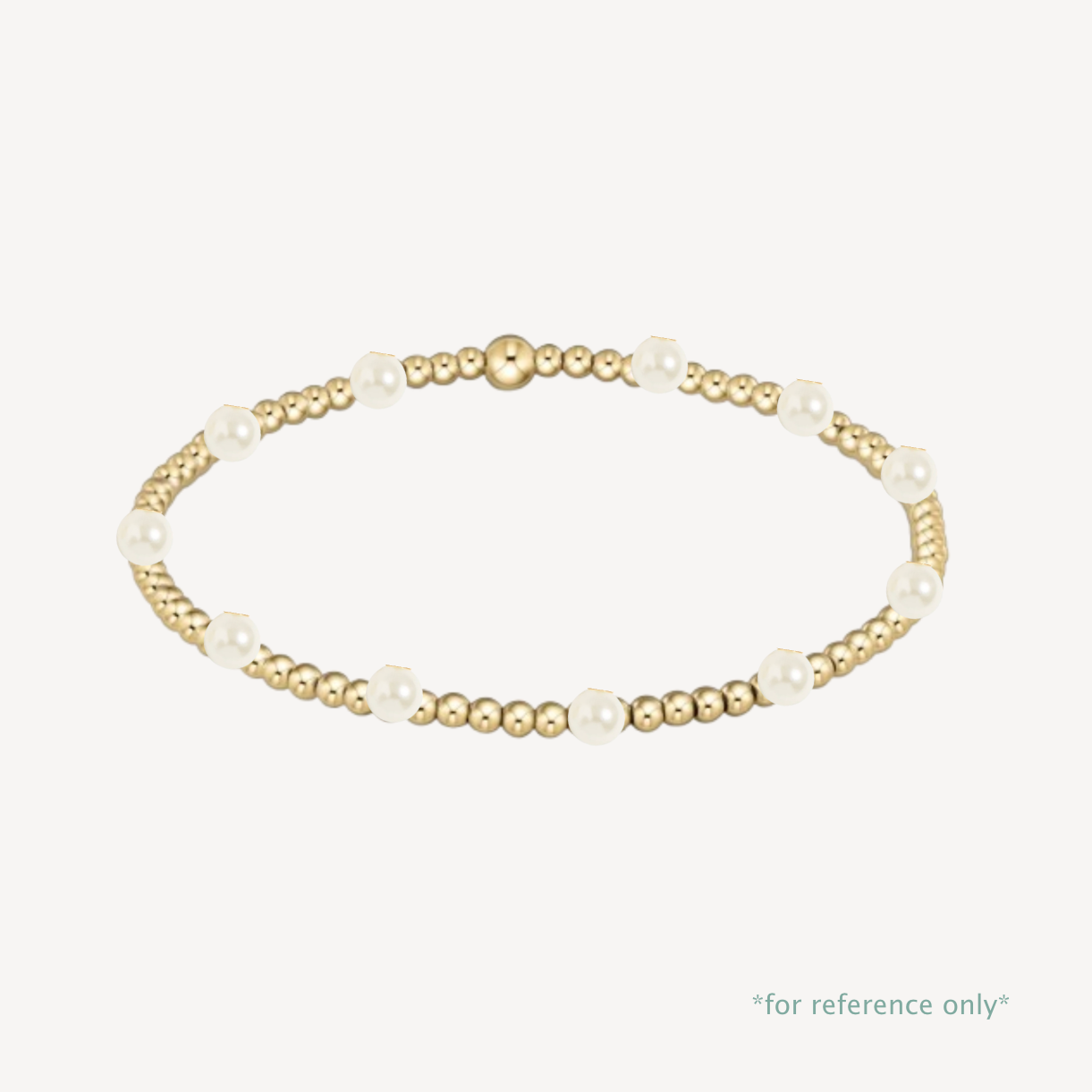 Gold and pearl bracelet on a white background
